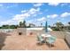 Open roof deck with multiple seating areas and beautiful views of palm trees and the blue sky at 1230 Gulf Blvd # 304, Clearwater, FL 33767