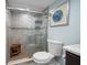 Updated tile and glass shower with seat adds to the bathroom's ambiance at 1230 Gulf Blvd # 304, Clearwater, FL 33767