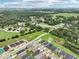 An aerial view shows this home's location in a community near ponds and wooded areas at 12937 Ogden Glade Rd, Dade City, FL 33525