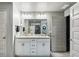 Well-lit bathroom featuring double sinks, granite countertops, modern fixtures, and ample cabinet space at 12937 Ogden Glade Rd, Dade City, FL 33525