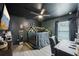 Unique bedroom featuring a black ceiling, wood-look floors, and a custom-built bed frame with fairy lights at 12937 Ogden Glade Rd, Dade City, FL 33525
