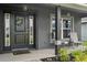 Cozy front porch with seating area, decorative wreath and pendant lighting creating an inviting entryway at 12937 Ogden Glade Rd, Dade City, FL 33525