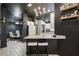 Open-concept eat-in kitchen with black ceiling, white cabinets, granite countertop, and seating area at 12937 Ogden Glade Rd, Dade City, FL 33525
