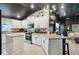 Modern kitchen with white cabinets, granite countertops, stainless steel appliances, and stylish lighting at 12937 Ogden Glade Rd, Dade City, FL 33525
