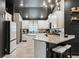 Modern eat-in kitchen with black ceilings, white cabinets, granite counters, and stylish bar stool seating at 12937 Ogden Glade Rd, Dade City, FL 33525