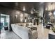 Open-concept living space featuring a large sofa, stylish mirrors, and elegant lighting fixtures at 12937 Ogden Glade Rd, Dade City, FL 33525