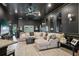Spacious living room with a comfortable seating area, modern lighting, and an open layout at 12937 Ogden Glade Rd, Dade City, FL 33525