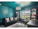 Stylish office with turquoise walls, contemporary chandelier, black furnishings, and neighborhood view at 12937 Ogden Glade Rd, Dade City, FL 33525