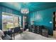 Cozy turquoise home office featuring stylish furnishings and a view of the outdoors at 12937 Ogden Glade Rd, Dade City, FL 33525