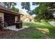 Spacious backyard with a patio, grill, and green space, perfect for outdoor activities at 1380 Azalea Dr # 1701, Dunedin, FL 34698