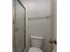 This bathroom features a toilet, towel rack, and glass enclosed shower with white tile surround at 1380 Azalea Dr # 1701, Dunedin, FL 34698