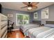This bedroom features two comfortable beds, a ceiling fan and a large window with plenty of natural light at 1380 Azalea Dr # 1701, Dunedin, FL 34698