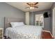 This bedroom features a comfortable bed, a ceiling fan and a large window with plenty of natural light at 1380 Azalea Dr # 1701, Dunedin, FL 34698