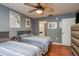 The bedroom contains two twin beds with blue and white striped comforters, wood floors, and neutral colored walls at 1380 Azalea Dr # 1701, Dunedin, FL 34698