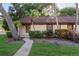 Charming single-story home featuring lush landscaping and a welcoming walkway at 1380 Azalea Dr # 1701, Dunedin, FL 34698