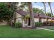 Charming single-story home featuring lush landscaping and a welcoming entrance at 1380 Azalea Dr # 1701, Dunedin, FL 34698