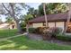 Well-maintained exterior with lush landscaping and a charming walkway leading to the entrance at 1380 Azalea Dr # 1701, Dunedin, FL 34698
