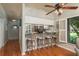 Eat-in kitchen with bar stool seating, hardwood flooring, and window with shutters at 1380 Azalea Dr # 1701, Dunedin, FL 34698