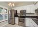 Modern kitchen with stainless steel appliances, ample storage, and tile flooring at 1380 Azalea Dr # 1701, Dunedin, FL 34698