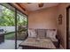 This cozy screened lanai has comfortable seating and a tile-topped table with a view of the backyard at 1380 Azalea Dr # 1701, Dunedin, FL 34698