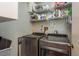 This is a laundry room featuring a modern washer and dryer along with metal shelving for storage at 1380 Azalea Dr # 1701, Dunedin, FL 34698