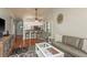 Open-concept living room featuring kitchen views, living area, hardwood flooring, and ample light at 1380 Azalea Dr # 1701, Dunedin, FL 34698