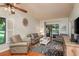 Cozy living room featuring comfortable seating, area rug, and access to the outdoor patio at 1380 Azalea Dr # 1701, Dunedin, FL 34698