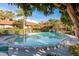 Inviting community pool with lush landscaping and a secure fence, promising endless summer fun at 1380 Azalea Dr # 1701, Dunedin, FL 34698