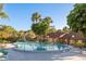 Community pool surrounded by tropical landscaping, offering a serene retreat at 1380 Azalea Dr # 1701, Dunedin, FL 34698