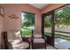 Relaxing sunroom with comfortable wicker chairs and a view of the landscaped yard at 1380 Azalea Dr # 1701, Dunedin, FL 34698