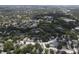 Expansive aerial view of a residential community featuring multiple ponds, mature trees, and a swimming pool at 13907 Fletchers Mill Dr, Tampa, FL 33613