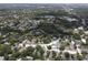Aerial shot showcasing the neighborhood's layout, including ponds, tennis courts, and mature landscaping at 13907 Fletchers Mill Dr, Tampa, FL 33613