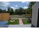 Outdoor living space with patio, seating area, fire pit, white picket fence, and lush landscaping at 13907 Fletchers Mill Dr, Tampa, FL 33613
