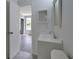 Bright bathroom featuring white vanity, modern fixtures, and tile flooring at 13907 Fletchers Mill Dr, Tampa, FL 33613