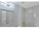Recently renovated bathroom features a stylish mirror, light fixture, and white marble tiled shower at 13907 Fletchers Mill Dr, Tampa, FL 33613