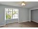 Well lit bedroom with large window and ceiling fan at 13907 Fletchers Mill Dr, Tampa, FL 33613
