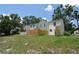 Two-story townhouse with lush green grass, backyard fence and mature trees offering shade at 13907 Fletchers Mill Dr, Tampa, FL 33613