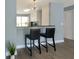 Open kitchen with bar seating, granite countertops, stainless steel appliances and modern lighting at 13907 Fletchers Mill Dr, Tampa, FL 33613