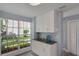 Additional kitchen cabinets offer extra storage, with a window view of the landscaped outdoors at 13907 Fletchers Mill Dr, Tampa, FL 33613