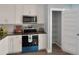 Well-equipped kitchen with modern appliances, including a microwave and oven, and a pantry at 13907 Fletchers Mill Dr, Tampa, FL 33613