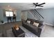 Open-concept living room with modern flooring, neutral paint, and stylish staircase at 13907 Fletchers Mill Dr, Tampa, FL 33613