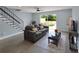 Inviting living room boasting modern flooring, staircase, and a view of the private backyard at 13907 Fletchers Mill Dr, Tampa, FL 33613