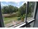 Scenic backyard pond view through home window at 13907 Fletchers Mill Dr, Tampa, FL 33613