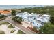Scenic aerial view of light blue townhomes, showcasing meticulous landscaping and convenient parking at 1413 Bayshore Blvd # 11, Dunedin, FL 34698