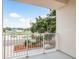 View of balcony overlooking street with beautiful landscaping and blue skies at 1413 Bayshore Blvd # 11, Dunedin, FL 34698