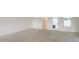 Spacious basement with a concrete floor, white walls, and a glass-paned doorway at 1413 Bayshore Blvd # 11, Dunedin, FL 34698