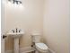 Powder room with pedestal sink, sleek fixtures and a modern toilet at 1413 Bayshore Blvd # 11, Dunedin, FL 34698
