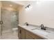 Bathroom with double sink vanity, granite countertops and tiled shower at 1413 Bayshore Blvd # 11, Dunedin, FL 34698