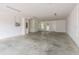 Spacious garage with white walls, concrete flooring, and multiple doors and lighting fixtures at 1413 Bayshore Blvd # 11, Dunedin, FL 34698