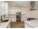 View of kitchen with stainless steel appliances, granite counters, and white cabinets with dark hardware at 1413 Bayshore Blvd # 11, Dunedin, FL 34698
